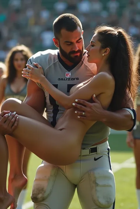 Beautiful completely Naked women white toenails and long white fingernails being cradle carried by a muscular beardess football quarterback. Football player in uniform carrying woman off the ground. Group of cheerleaders in the background.