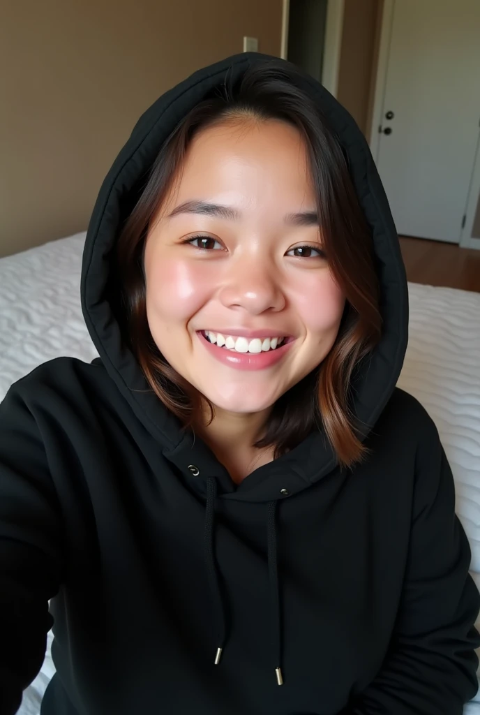 Selfie girl smile use black hoodie on bed
