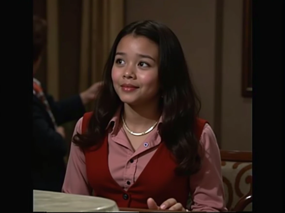 timid asian girl wearing long sleeve red button shirt, soft smile, sitting at a table, flat chested