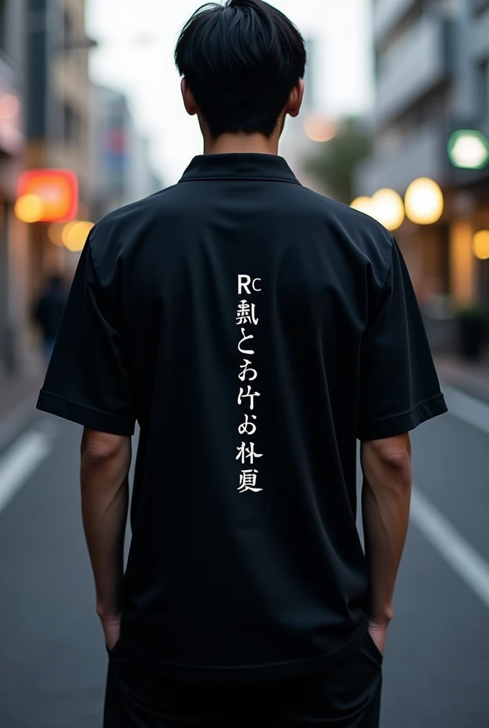 Black shirt with image on front and back, the front with a minimalist white RC logo and on the back a Japanese word in vertical 