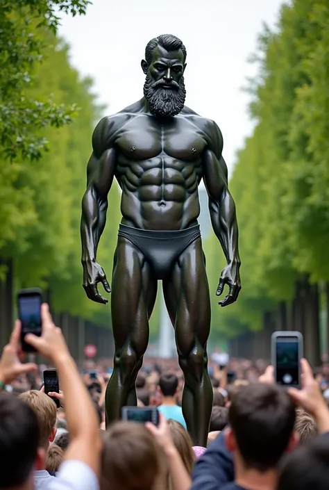 Statue in a park of a bearded man in underwear, being photographed by people.