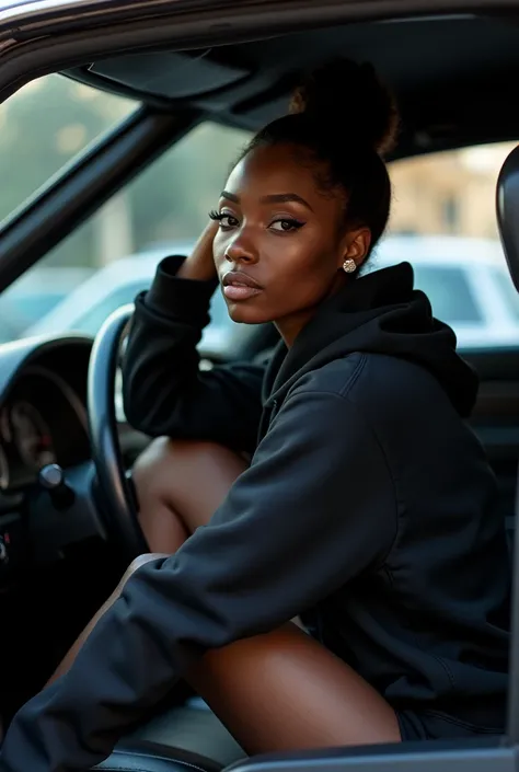 Black woman wearing leather short shorts up in crack black hoodie hair in a bun setting in car seat 