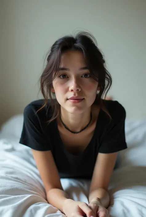 brunette, smile, flat chest, skinny face, white wall, no decoration, jean shorts, black t-shirt, lying on stomach on bed, looking at camera, photo from behind
