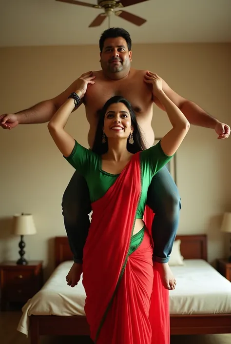 Beautiful and Slim Indian woman Aishwarya Rai in green blouse red saree lifting a large chubby man above her shoulders, man is sitting on womans shoulders, in a bedroom with high ceiling, natural smile, woman is looking into the camera , full body image 