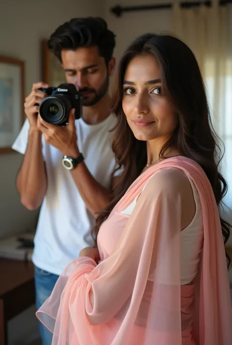 One 3 indian woman wears pink colour transparent saree and blouse, looking at camera and standing infront of a 2 indian handsome boy wears white tshirt who holds  camera in hand and clicking her photos, in their house.