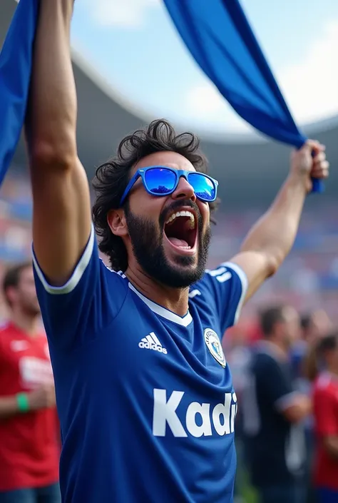 Show a Hertha Berlin football fan with flag in the stadium.
He has black hair and a beard. On his Hertha jersey is written Kadir. He also wears sunglasses Hertha club colors are white blue