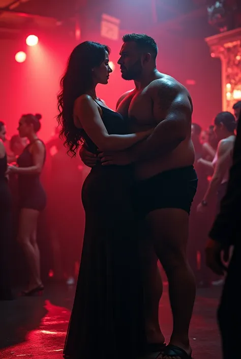 Sexy, stunning, girl lifting a man cradled in her strong arms. She is standing confidently in a night club wearing an elegant dress. The man is large and overweight. She is extremely strong.