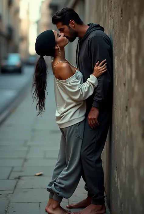 with black headscarf, white long sleeve t shirt, baggy grey sweatpants, barefoot sexy skinny woman. Man kissing woman with her back against the wall on the street.