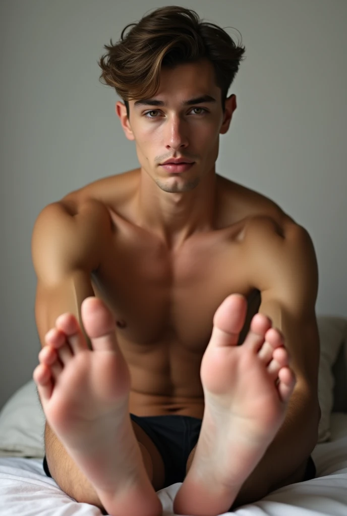 Create the image of a shirtless young man showing his feet