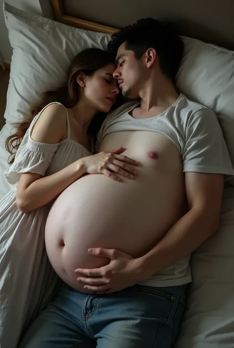 A young man with an enormous belly is laying with his back on the bed. His belly is enormous. A women is laying on the man’s very big belly and caress his belly. The both looks sad. 