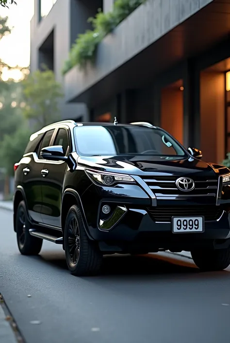 Fortuner with alloy wheels with 999 numberplate having zblack 
