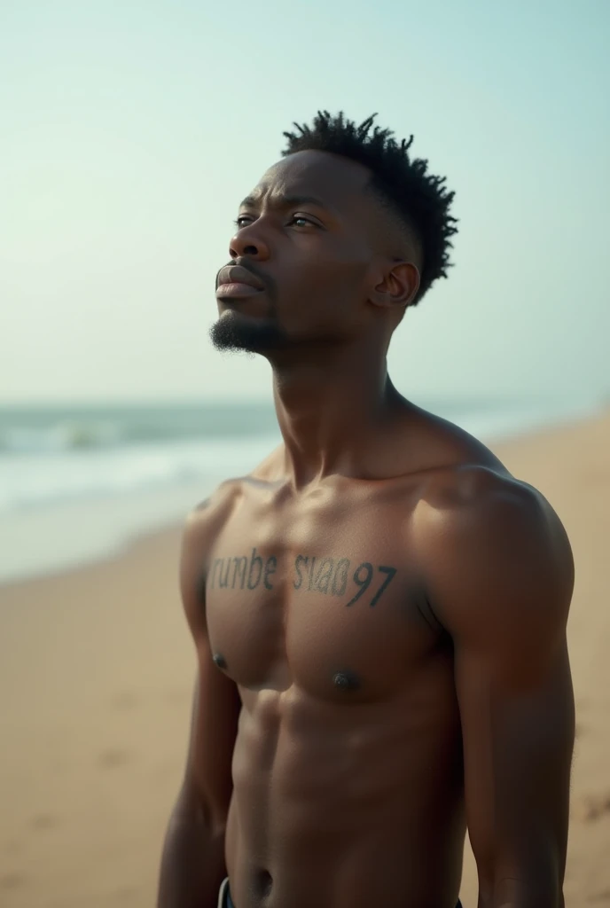 Young African man, short curly hair, Empty body, wearing jeans shorts. Tattoo Writing,Rumbewas97 on his chest. Standing on the edge of the beach 