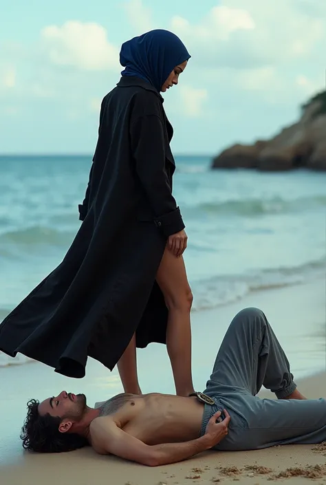 Navy blue headscarf on the beach, Black long coat, barefoot, Sexy skinny woman. Man lying in front of woman. Woman puts her foot on the front of man&#39;s sweatpants. 