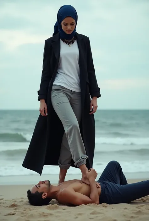 Navy blue headscarf on the beach, Black long coat, barelegged, white shirt,  skinny woman. Man lying in front of woman. Woman puts her foot on the front of man&#39;s sweatpants. 