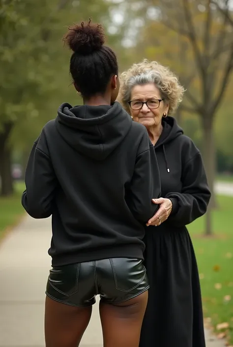 black woman hair in a bun black hoodie black leather short shorts bending over getting fucked in the ass by a old ugly woman in a dress in a park
