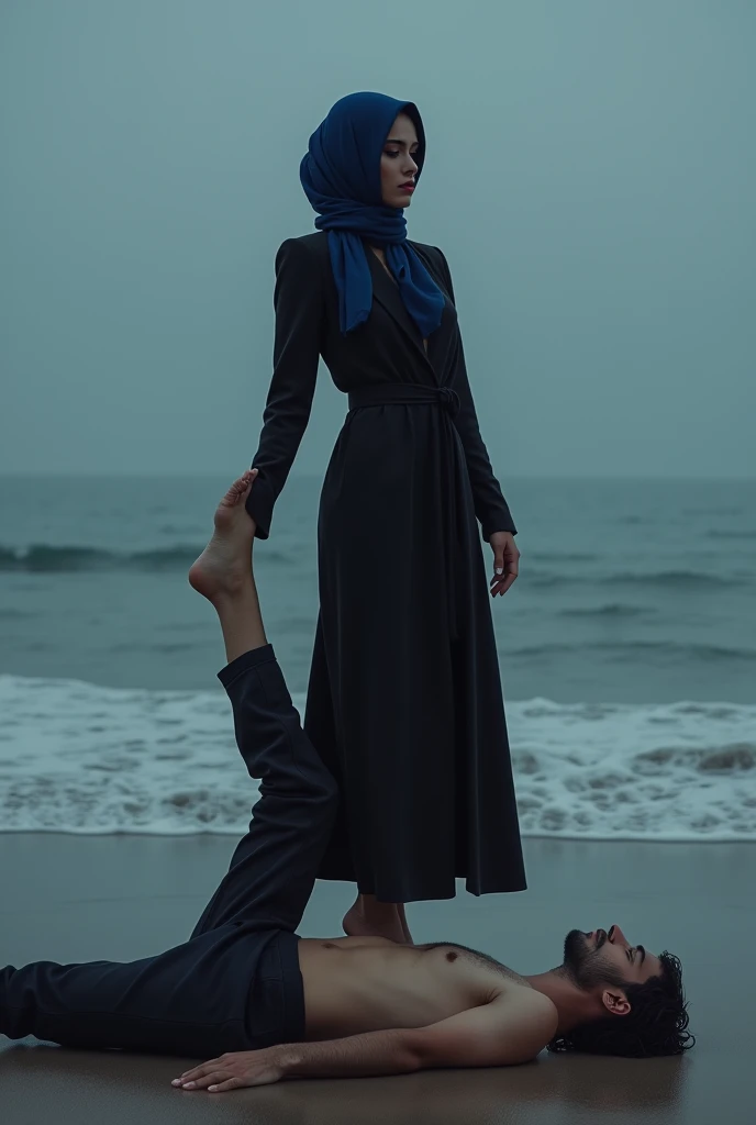 Navy blue headscarf on the beach, black long closed coat, barefoot, Sexy skinny woman. Man lying in front of woman. Woman puts her foot on man&#39;s sweatpants. 