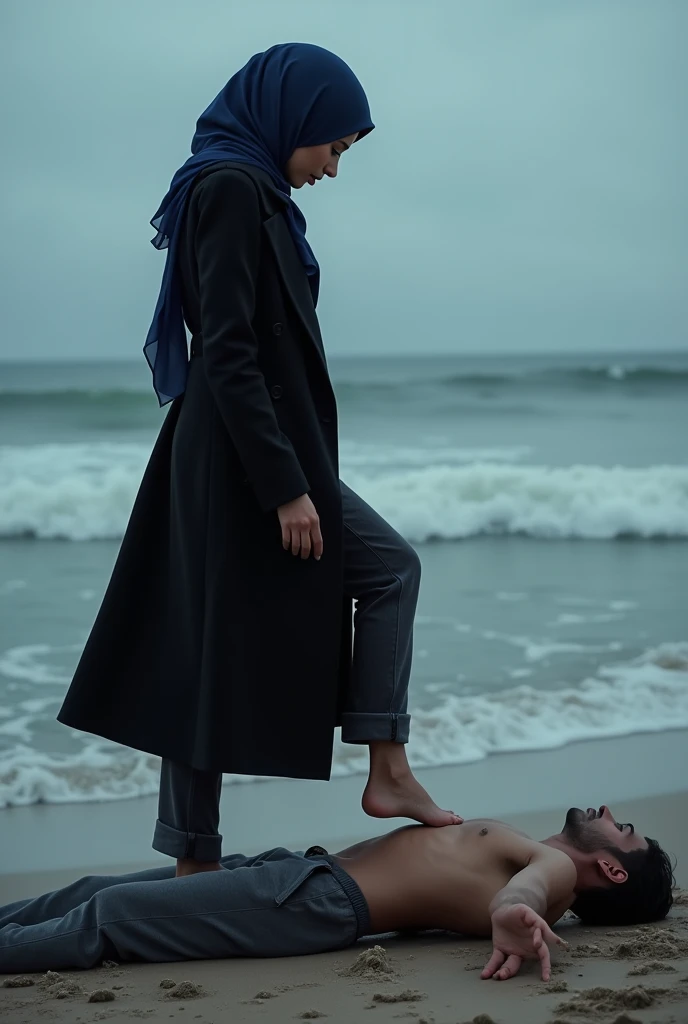 Navy blue headscarf on the beach, black long closed coat, barefoot, Sexy skinny woman. Man lying in front of woman. Woman puts her foot on man&#39;s sweatpants. 