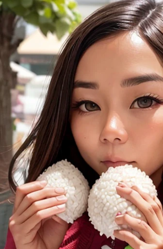 woman looking at camera holding rice ball close to her mouth、triangular rice balls