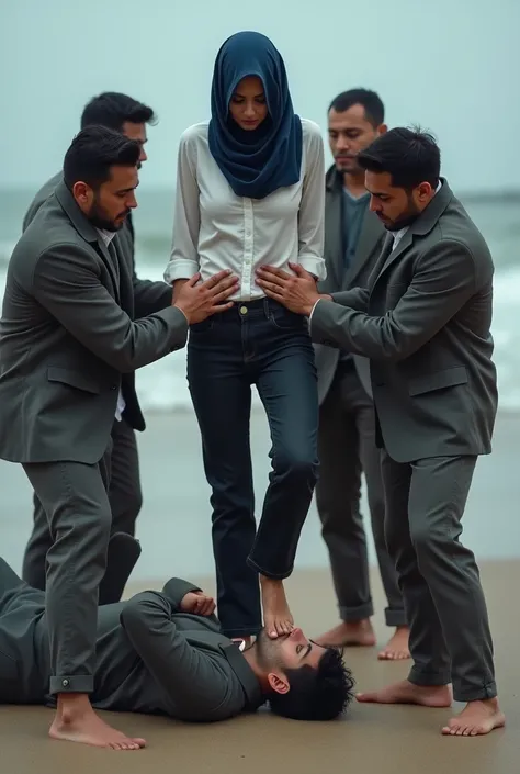 Navy blue headscarf on the beach, white shirt, black baggy jeans, barefoot skinny woman. Man lying in front of woman. Woman puts her foot on man&#39;s sweatpants. Three other men touch the woman&#39;s waist. 