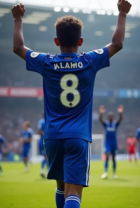 A  black boy ,in chelsea soccer team jeresey ,his name  ALEX ,number 8. and showing his back ,and him celebrating after a goal