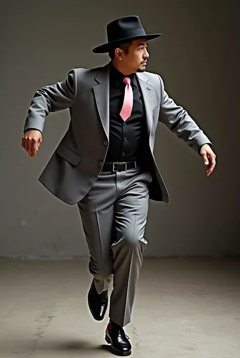 Indigenous man dancing Morenada in a grey suit, black shirt, baby pink tie, black hat and black shoes 