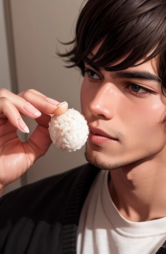 A young man eating a triangular rice ball