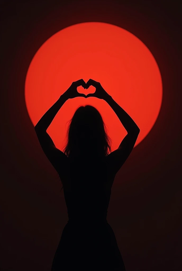 Silhouette of a woman from behind making a heart shape with her hands looking at the planet Mars