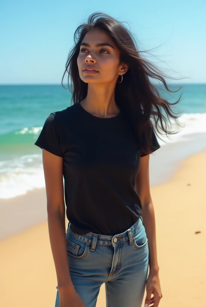 Indian girl with black T-shirt and jeans on beach