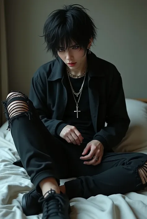 Goth boy with long messy black hair wearing a black jacket and a black shirt with several piercings in his ears and a cross shaped earring wearing baggy ripped black pants with black sneakers on a bed unzipping his pants 