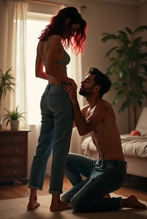 At Home Black wavy hair part of her hair is red, baggy jeans, barefoot sexy skinny woman. Man kneeling in front of woman. Man kisses woman&#39;s pants. 