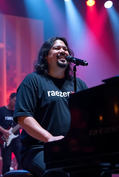 A chubby-faced Indonesian man with long, messy hair wearing a black t-shirt with the words "Raezer.X" is seen singing while playing the piano in the middle of a rock concert with the personnel wearing black t-shirts with the words "Raezer.X". The stage atm...