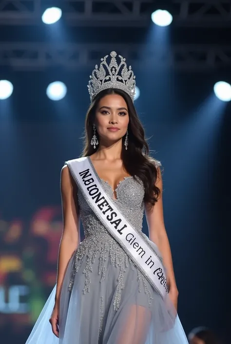 Miss International Indonesia wear crown, sash and silver evening gown at stage. Indonesian face