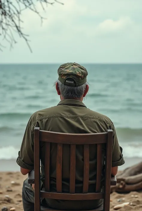 A man with wearing army cap and goggles sit in the chair and watching the sea in to the beach
