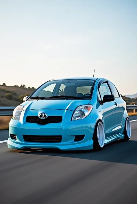 Toyota IST Car Year 2006 In light blue color with white sports rim and lowered Photo taken from the front on a highway