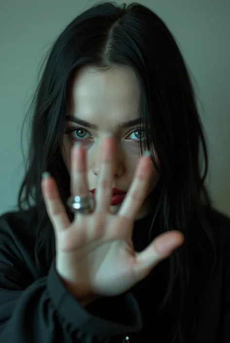 Billie Eilish doing 1 with her hand 