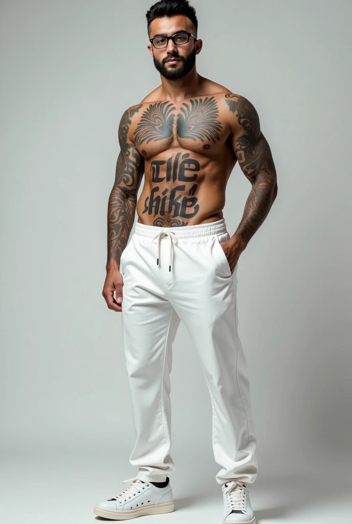 A young, light-skinned, muscular man with tattoos has black glasses and a beard. He wears white pants and tennis shoes. On his chest he has a tattoo with the text "Kike." 