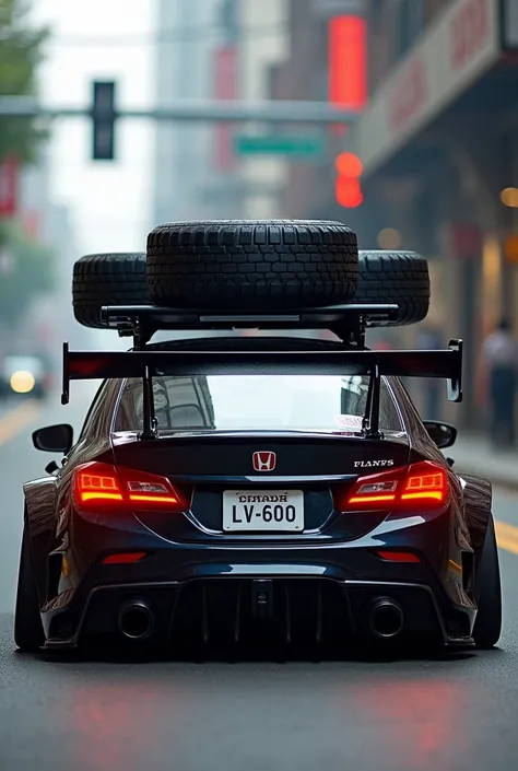 Honda City car with big spoiler and big tier on roof 
