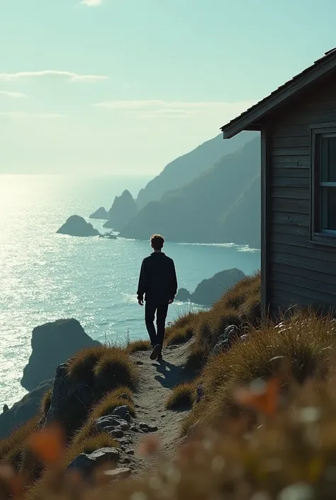 Young man walking away from cabin on the coast