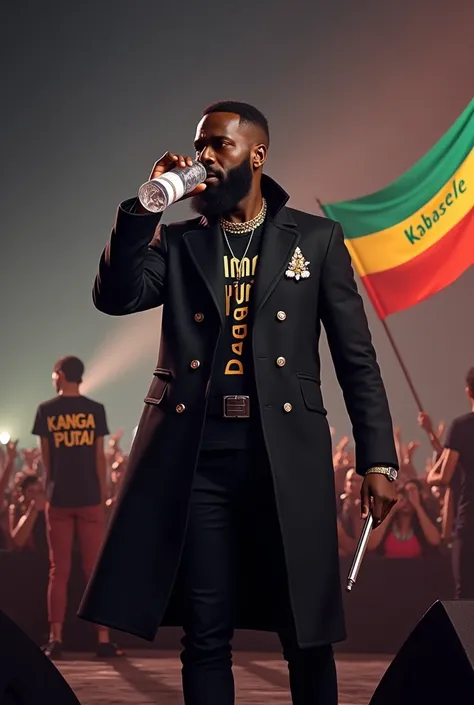 Fally ipupa wearing a black coat with the words KANGA DUBAI written on it, he is drinking water from a plastic bottle on the stage with a microphone in his hand, a spectator shows the flag with the words KABASELE written on it.