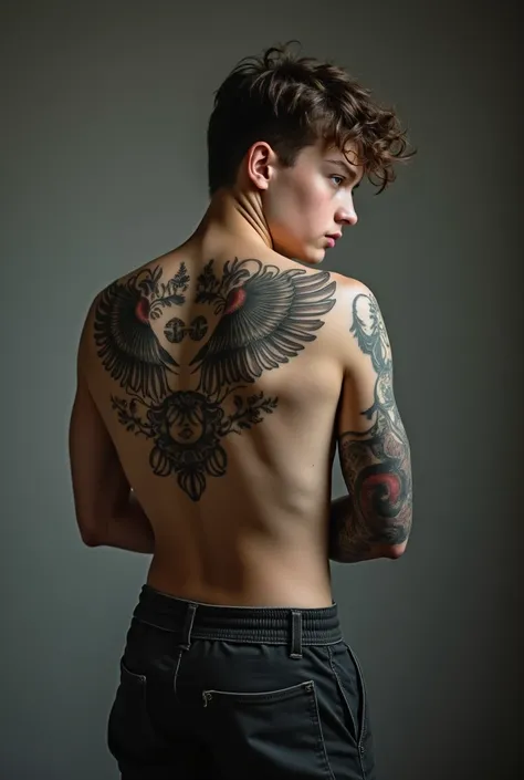 I need an image of 17 yr old boys by the back tattoo which covers a scar from a previous traumatic incidence  , a small tattoo
