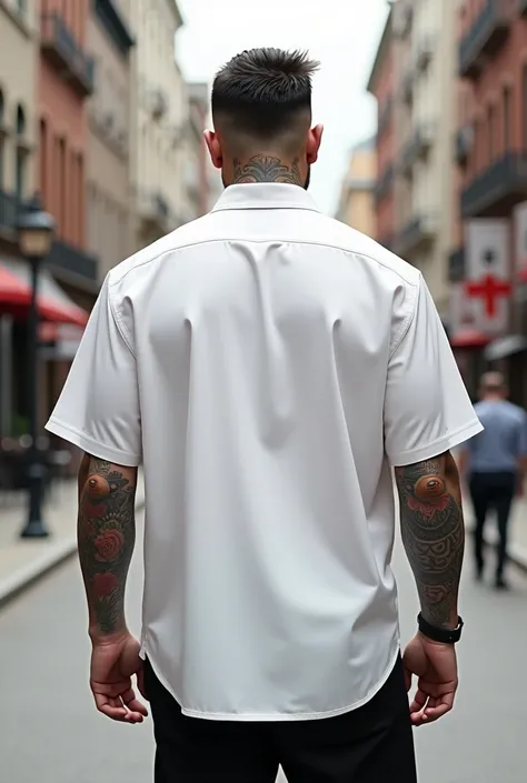 Create a mock up of a white shirt with a model with a background as if he were on the street with his back turned (the model has tattoos ) make it more realistic (that the shirt is wide like the new style called oversize)