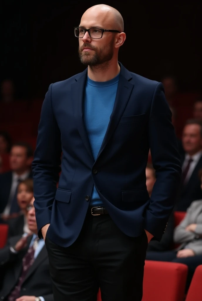 A young man, bald, with glasses, using a formal and social look for a lecture at an event.  The model is wearing a blue event t-shirt , well adjusted. over,  is a navy blue blazer , elegantly closed .  The lower part consists of black tailoring pants, that...