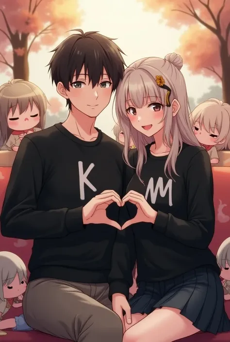 Photographs with the initials on his black sweater k for man and m for woman, as a couple, with anime cartoons The couple is sitting and they are forming a heart with their hands