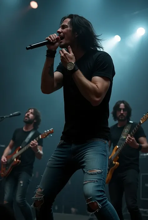 A male rocker is singing while screaming, long black hair, black t-shirt, torn blue jeans, holding a mic. Stage background with a complete band with players.