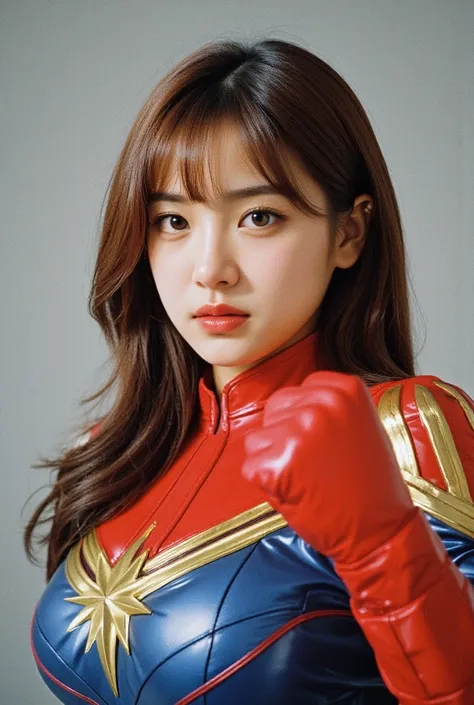 a cute korean girl cosplaying as captain marvel, a marvel comics character. her breasts are huge and beautiful. she is striking ...