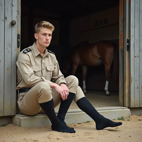 full length , a blond handsome 21 years old muscular cop with preppy short haircut, in beige uniform with tight breeches and long black thin dress socks, NO SHOES, sitting in in his socks front of the national stables of Haras du Pin, Normandy, France. His...