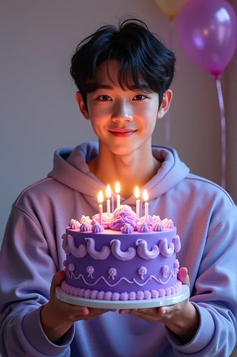 Jungkook of BTS holding a purple birthday cake