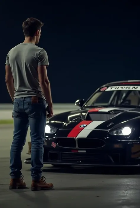 A pilot, in normal clothes , Dark, looking at your 2005 BMW M3 GTR, At night,  waiting for the next race 