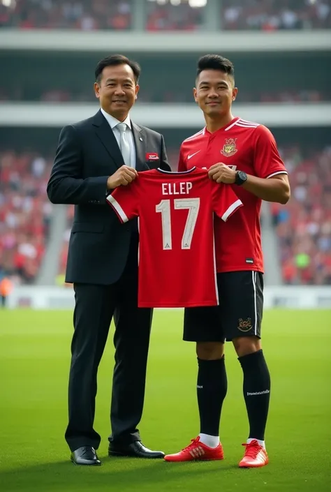  Photo Shin Tae-yong Indonesian national football coach,  wearing trousers and black jacket with Indonesian flag logo , complete with shoes , next to him was a handsome Asian man weighing 87 kg,  wearing Indonesian club shirt and wearing football shoes ,  ...