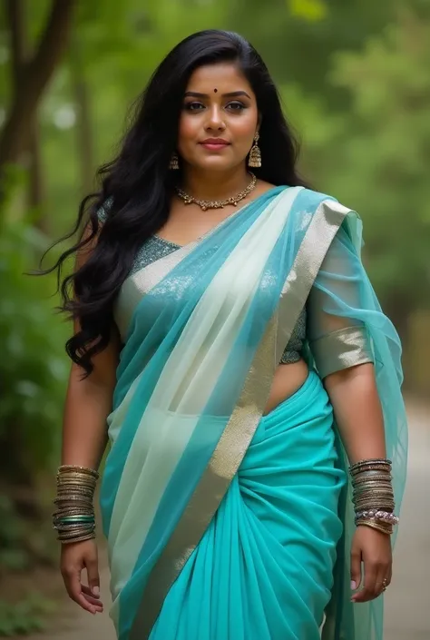 The plus size curvy aunty is wearing a vibrant blue saree with alternating light and dark blue stripes, giving it a modern and fresh appeal. The saree has a sheer, flowy texture and is paired with a sleeveless, shimmery silver blouse that provides a striki...